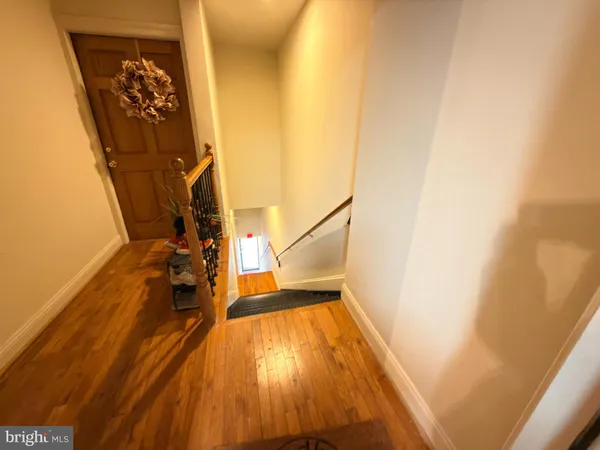 a view of a room with wooden floor