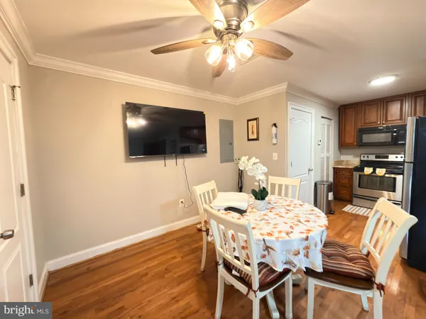 a view of a dining room with furniture and wooden floor