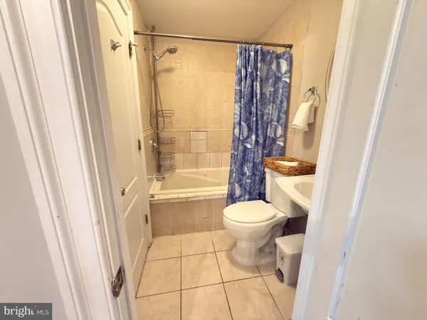 a bathroom with a toilet and a shower curtain
