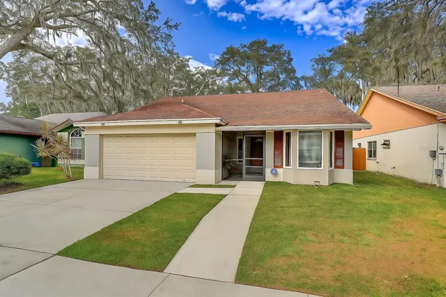 a front view of a house with a yard and porch