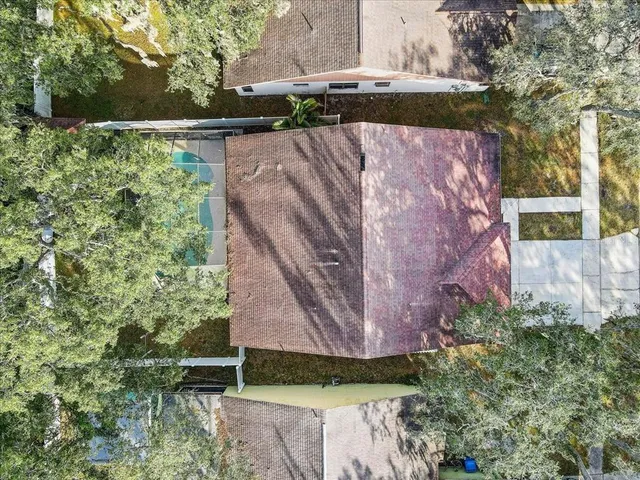 an aerial view of residential houses with outdoor space and lake view