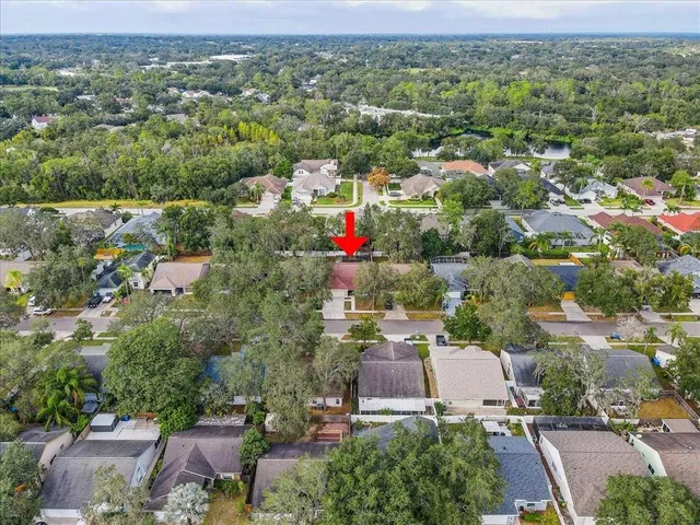 an aerial view of residential houses with outdoor space and parking