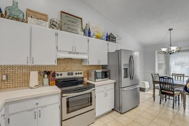 a kitchen with stainless steel appliances a sink stove and refrigerator
