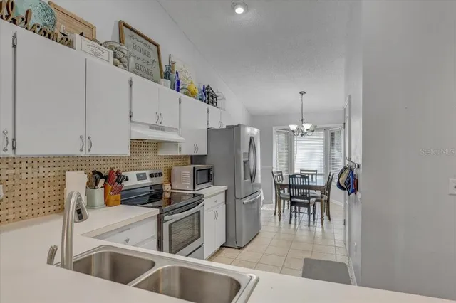 a view of a dining room with furniture and a chandelier