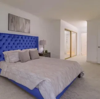 a bedroom with bed and window