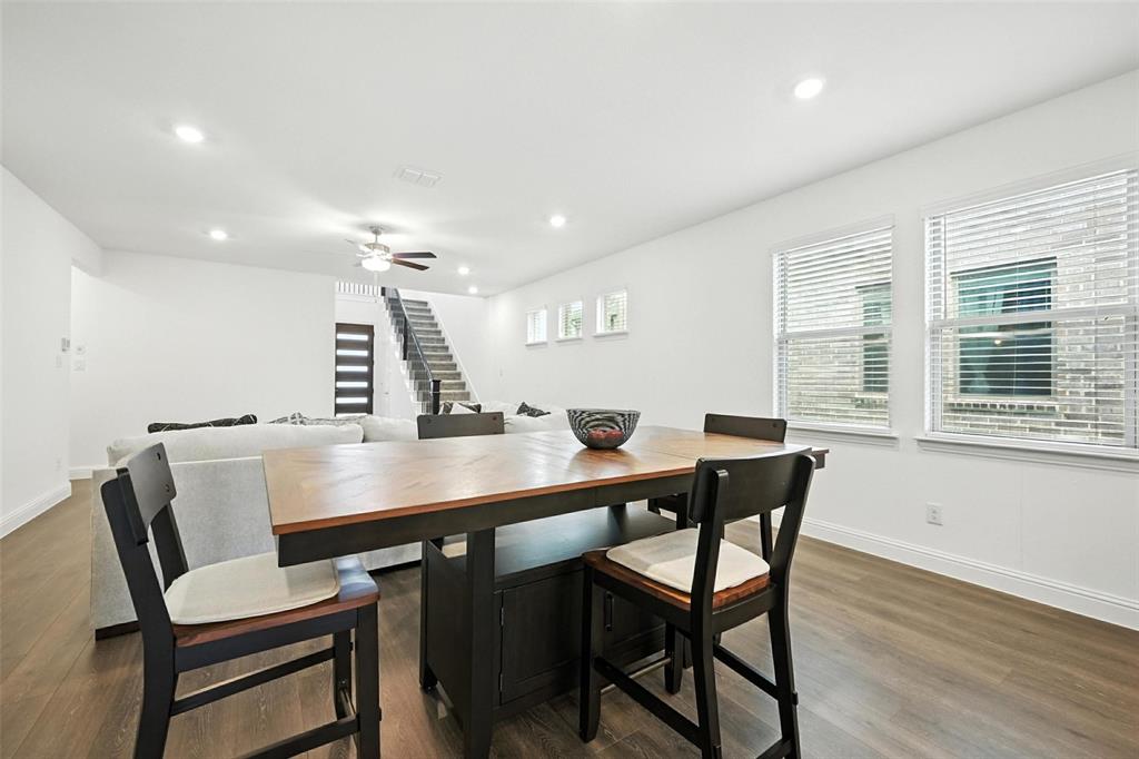 447 Holly Road Little Elm, TX 75068 - Photo 11 of 30 a view of a dining room with furniture and wooden floor
