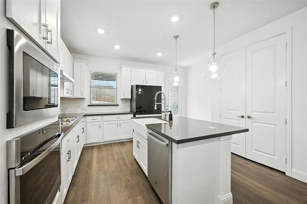 447 Holly Road Little Elm, TX 75068 - Photo 12 of 30 a kitchen with a sink stove and refrigerator