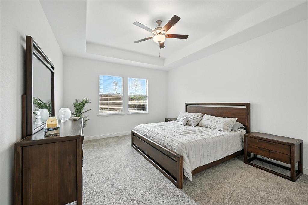 447 Holly Road Little Elm, TX 75068 - Photo 15 of 30 a bedroom with a bed and a large window