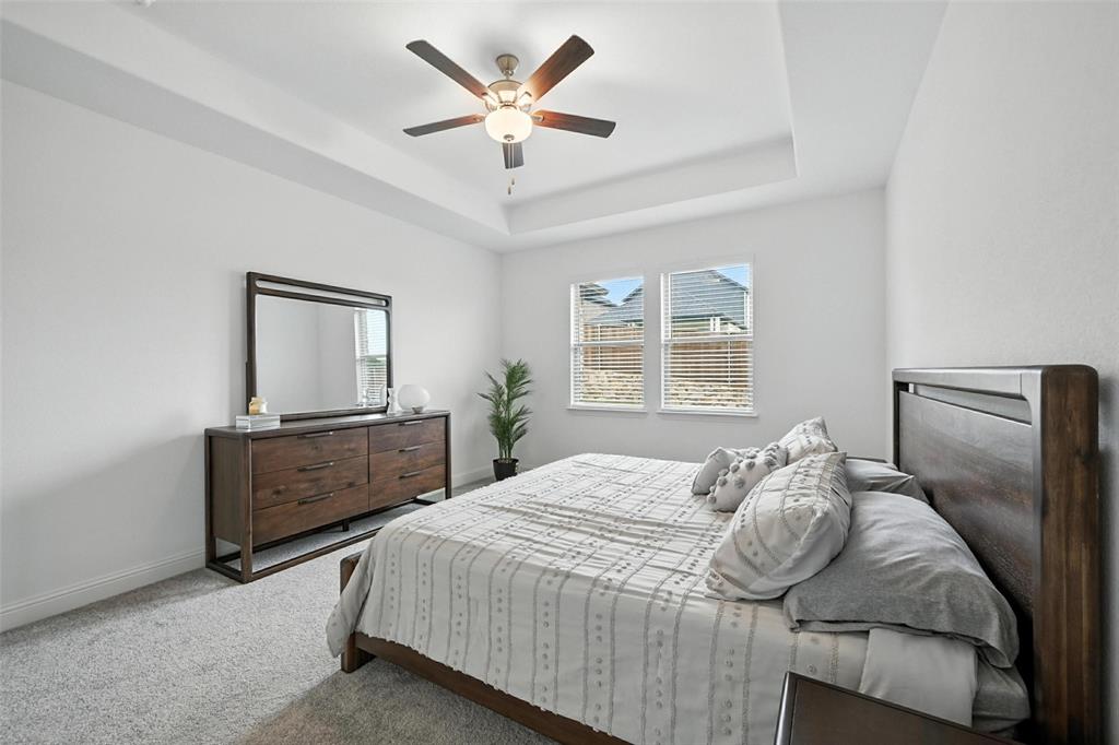 447 Holly Road Little Elm, TX 75068 - Photo 16 of 30 a bedroom with a bed dresser and window