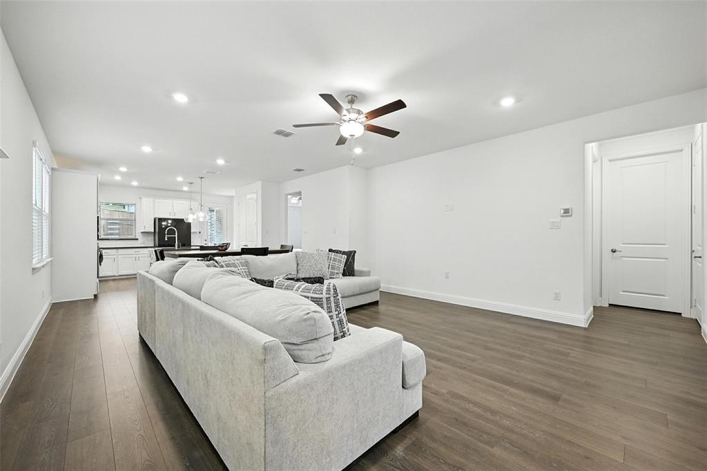 447 Holly Road Little Elm, TX 75068 - Photo 7 of 30 a living room with furniture and a view of kitchen