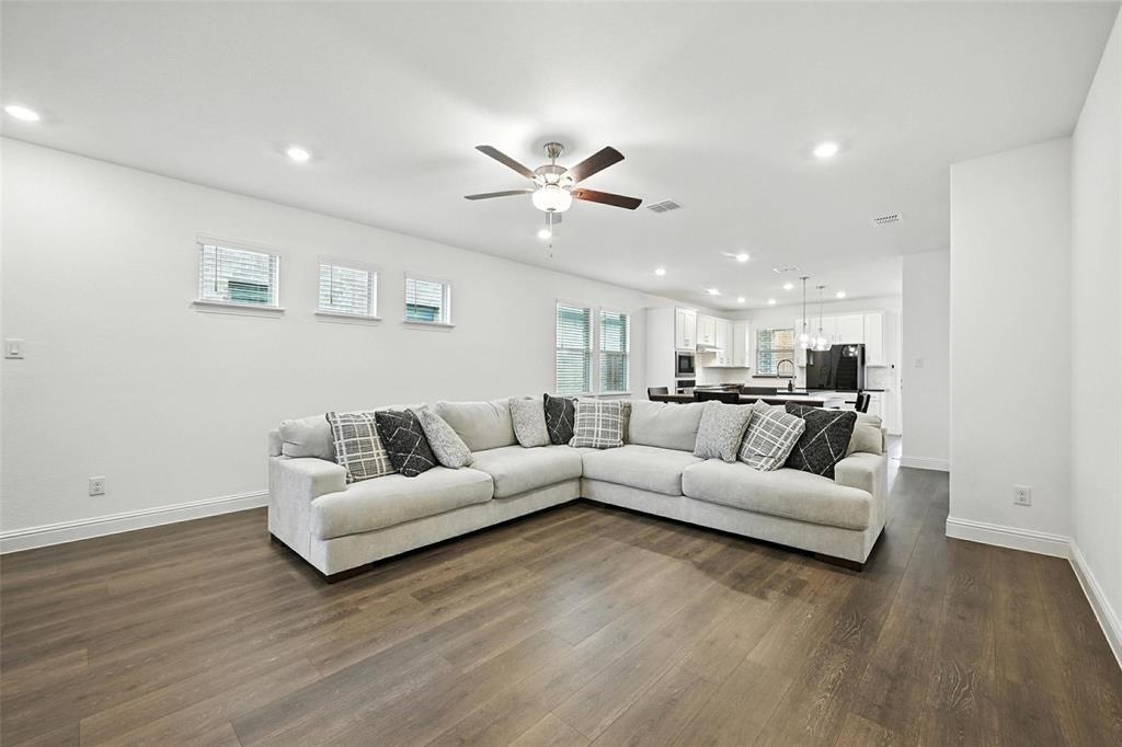 447 Holly Road Little Elm, TX 75068 - Photo 8 of 30 a living room with furniture and a wooden floor