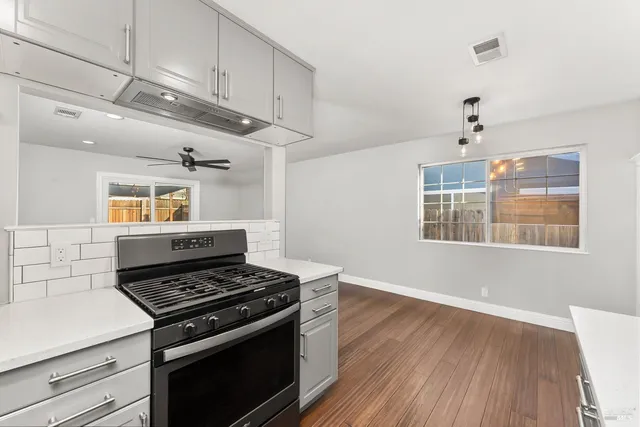 a stove top oven sitting inside of a kitchen