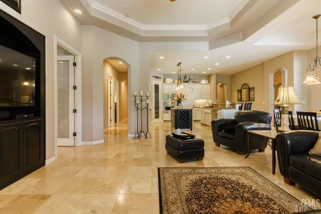 a living room with lots of furniture and kitchen view