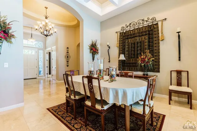 a view of a dining room with furniture and chandelier