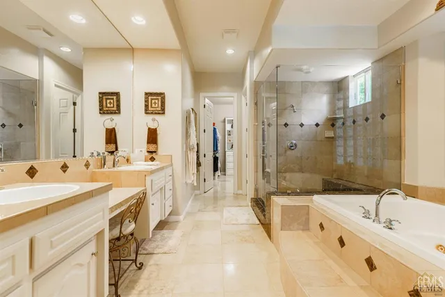 a bathroom with a tub sink and mirror