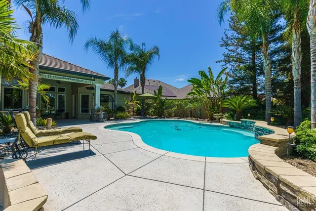 a view of a swimming pool and a yard