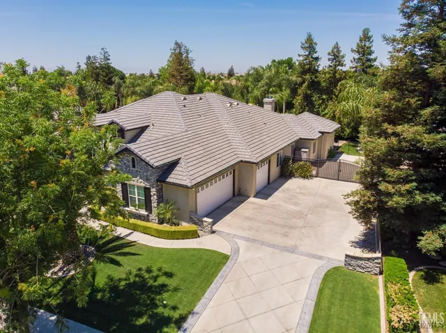 a aerial view of a house with a yard table and chairs