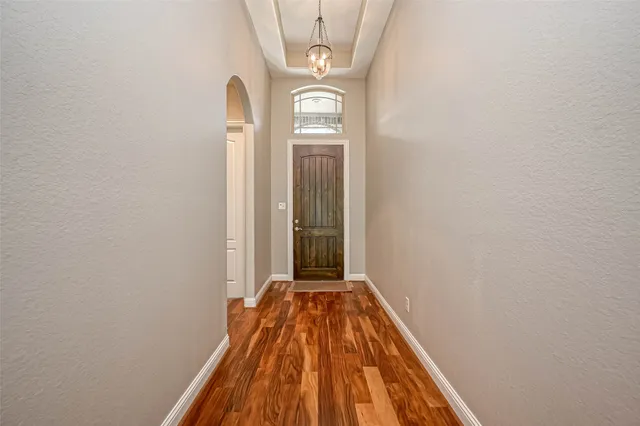 a view of a livingroom with wooden floor and a window