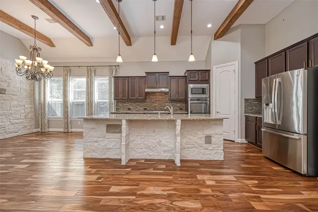 a view of kitchen with refrigerator and window