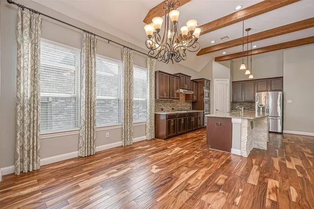 a large kitchen with kitchen island a sink stainless steel appliances and cabinets