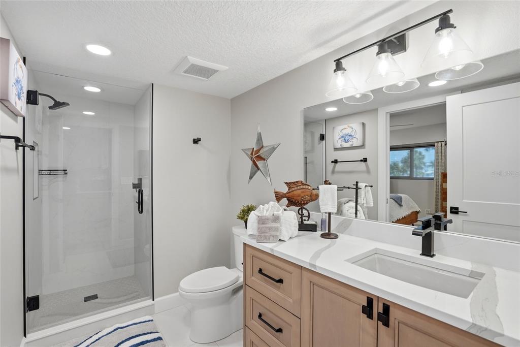 363 Pinellas Bayway South, Unit 29 Tierra Verde, FL 33715 - Photo 8 of 59 a bathroom with a sink a toilet and shower