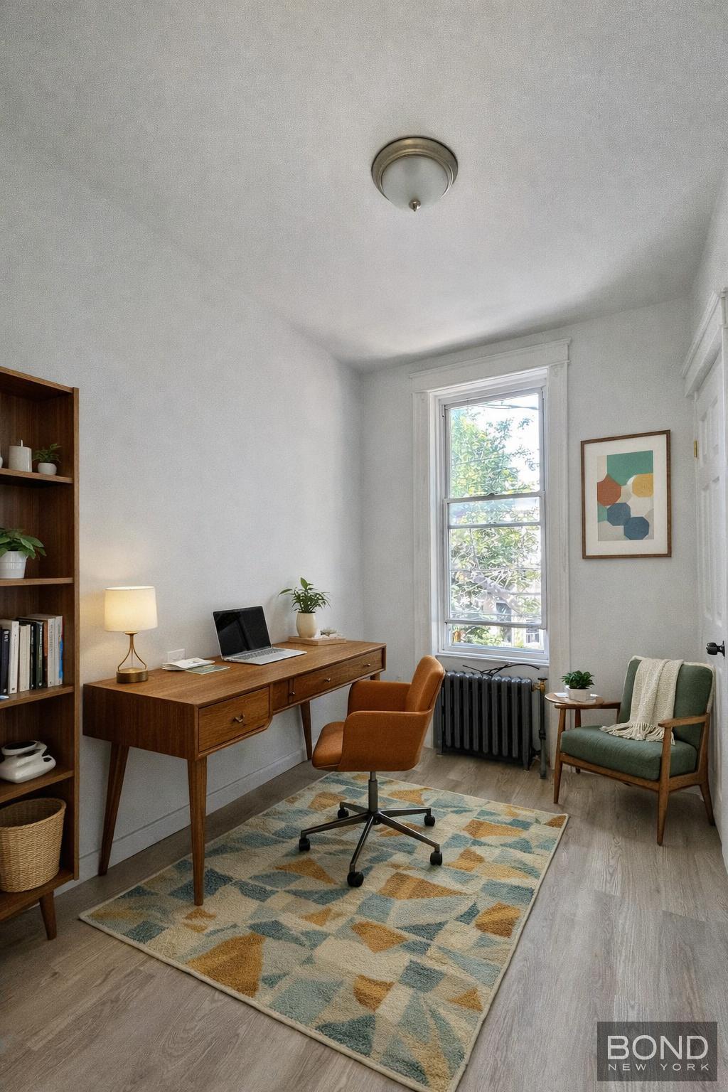 60-36 68th Road, Unit 2 Queens, NY 11385 - Photo 4 of 5 a workspace with furniture and a window