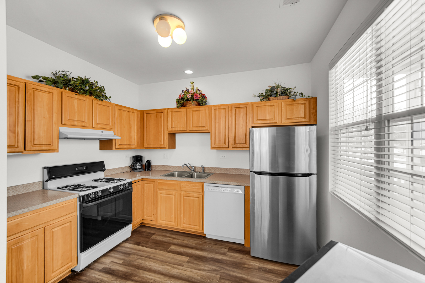 1397 Fox Hound Trail Beecher, IL 60401 - Photo 11 of 23 a kitchen with a sink a refrigerator a stove and a window