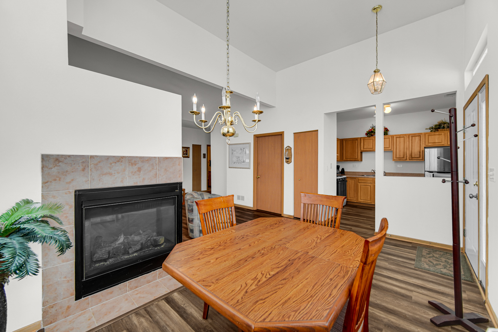 1397 Fox Hound Trail Beecher, IL 60401 - Photo 12 of 23 a open kitchen view with fireplace a sink and refrigerator