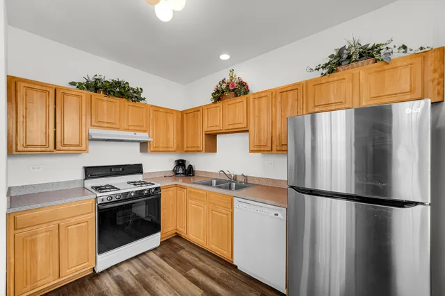 a kitchen with stainless steel appliances a refrigerator stove and sink