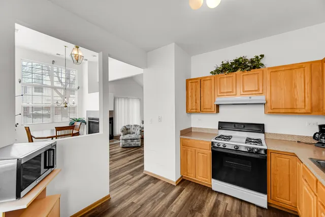 a kitchen with stainless steel appliances a stove a sink and a refrigerator