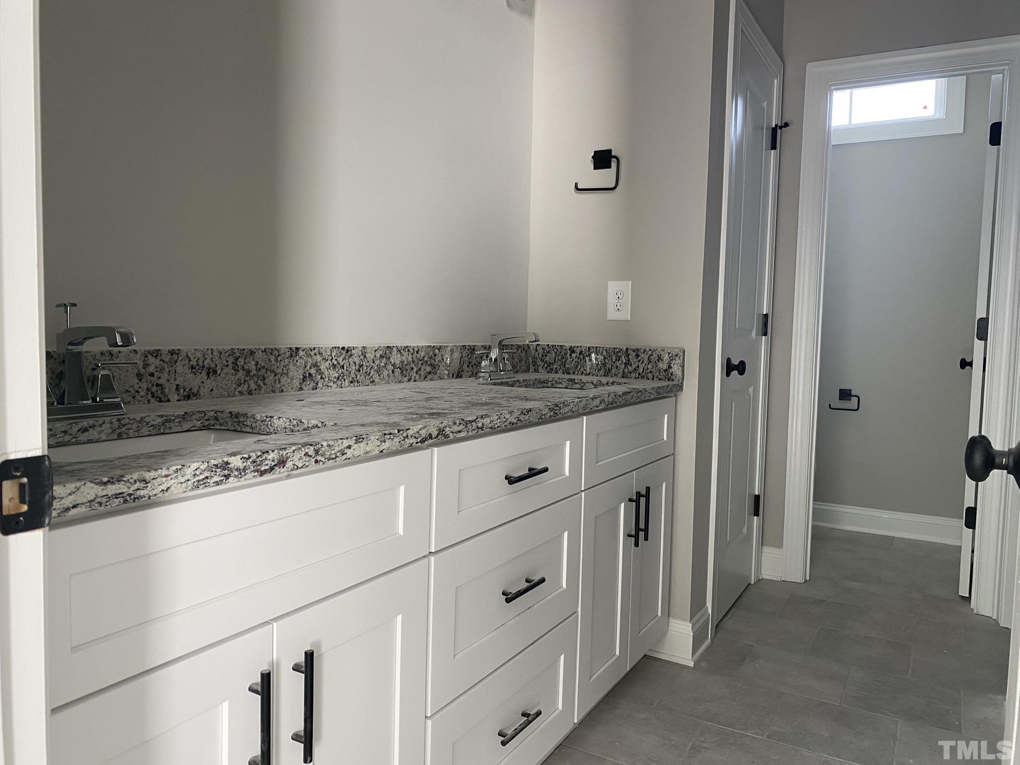 102 Buckstone Place Willow Spring, NC 27592 - Photo 14 of 25 a bathroom with a granite countertop sink and a mirror