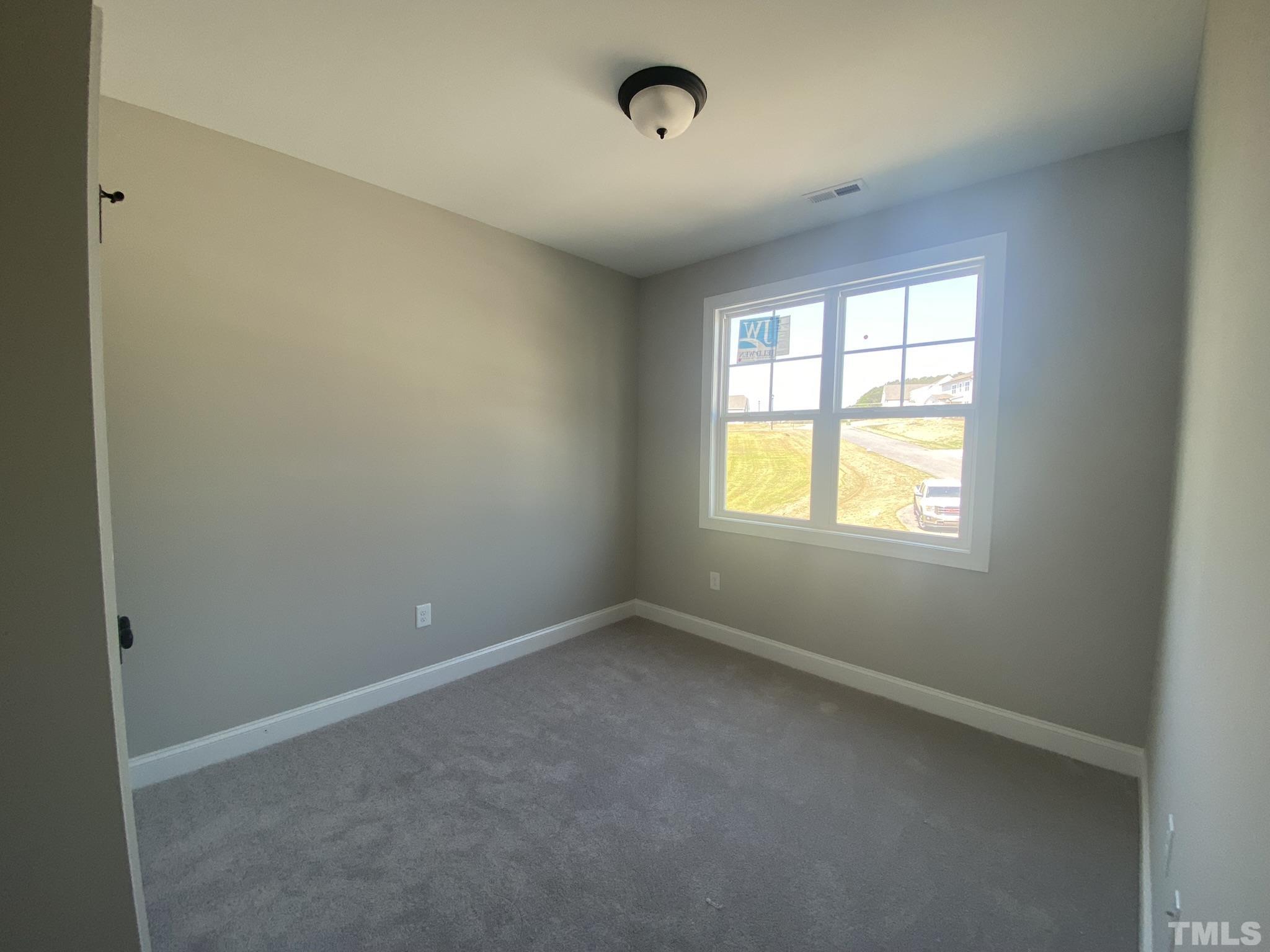 102 Buckstone Place Willow Spring, NC 27592 - Photo 17 of 25 an empty room with a window