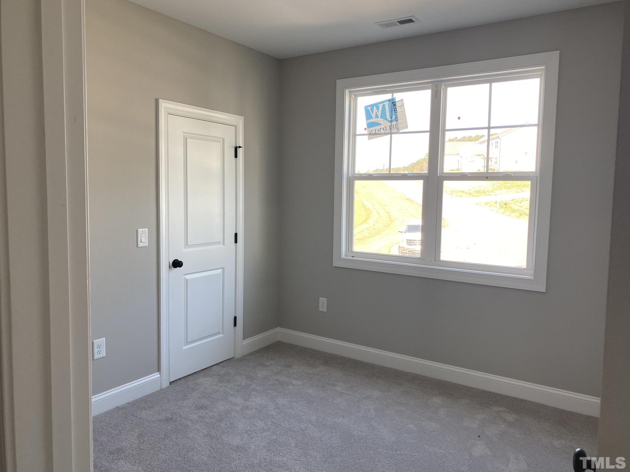 102 Buckstone Place Willow Spring, NC 27592 - Photo 18 of 25 a view of an empty room with a window