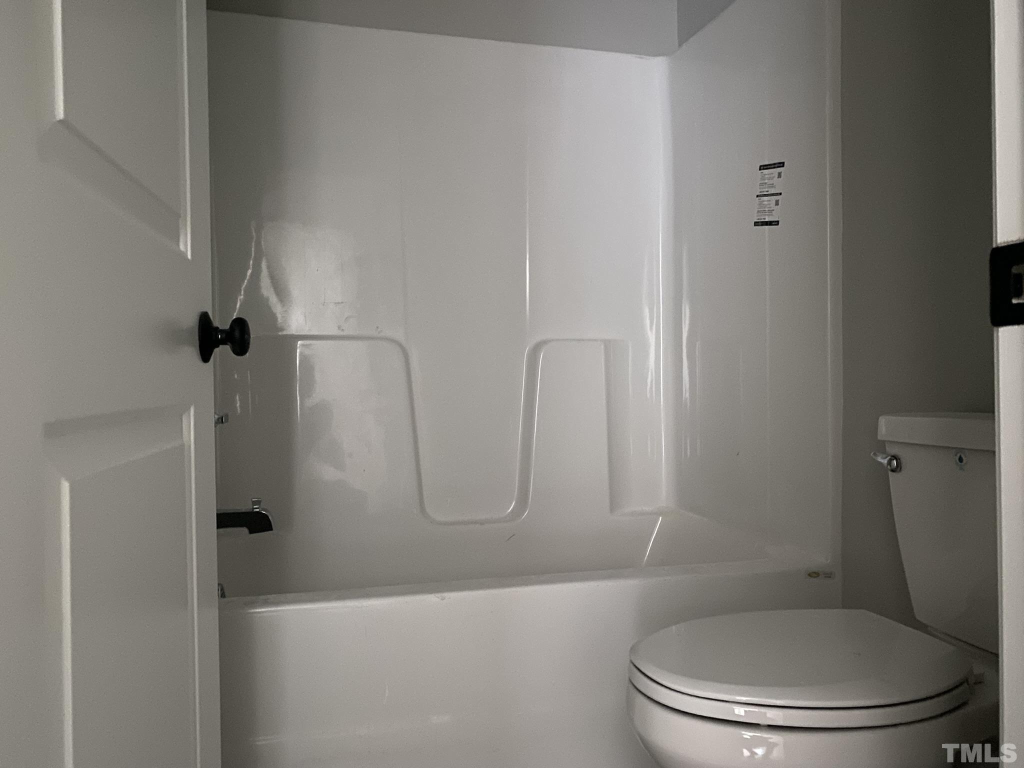 102 Buckstone Place Willow Spring, NC 27592 - Photo 21 of 25 a white toilet sitting next to a bath tub