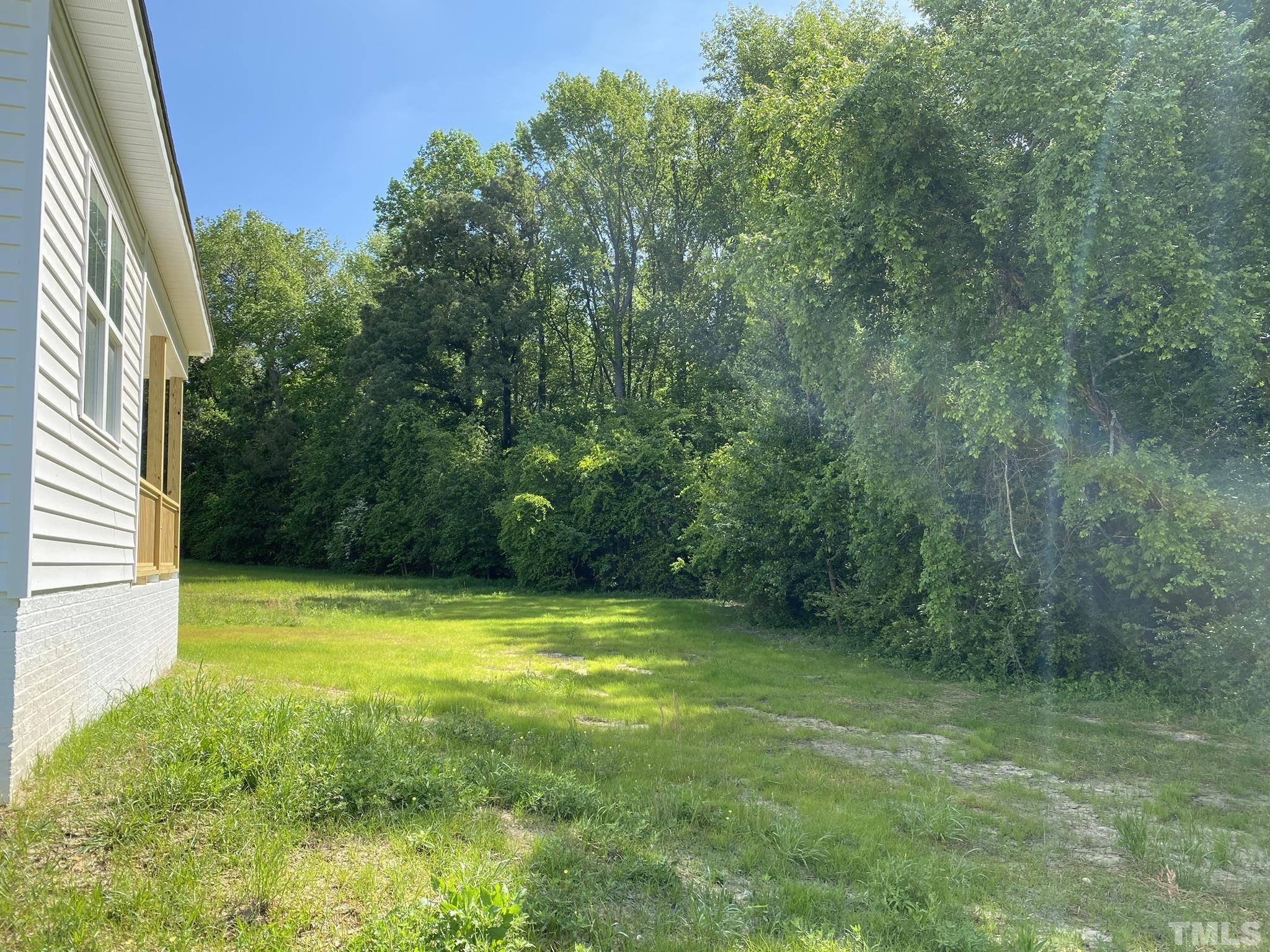 102 Buckstone Place Willow Spring, NC 27592 - Photo 25 of 25 a view of a swimming pool with a yard