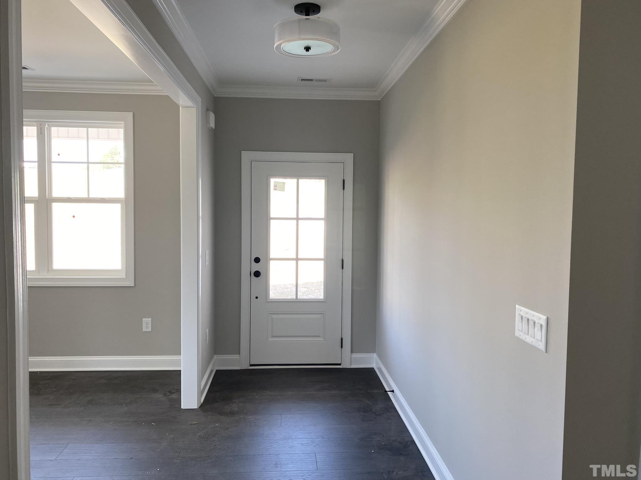102 Buckstone Place Willow Spring, NC 27592 - Photo 3 of 25 an empty room with wooden floor and windows