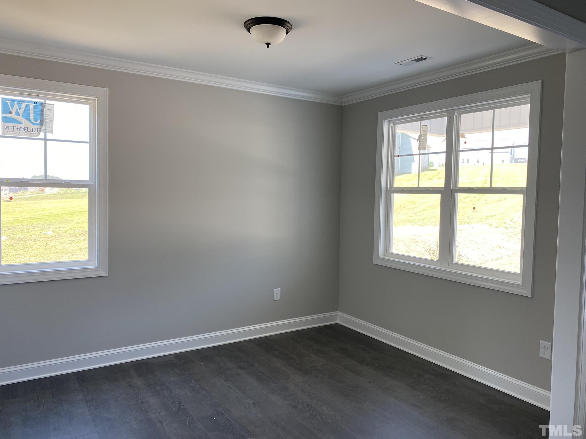 102 Buckstone Place Willow Spring, NC 27592 - Photo 4 of 25 an empty room with a window