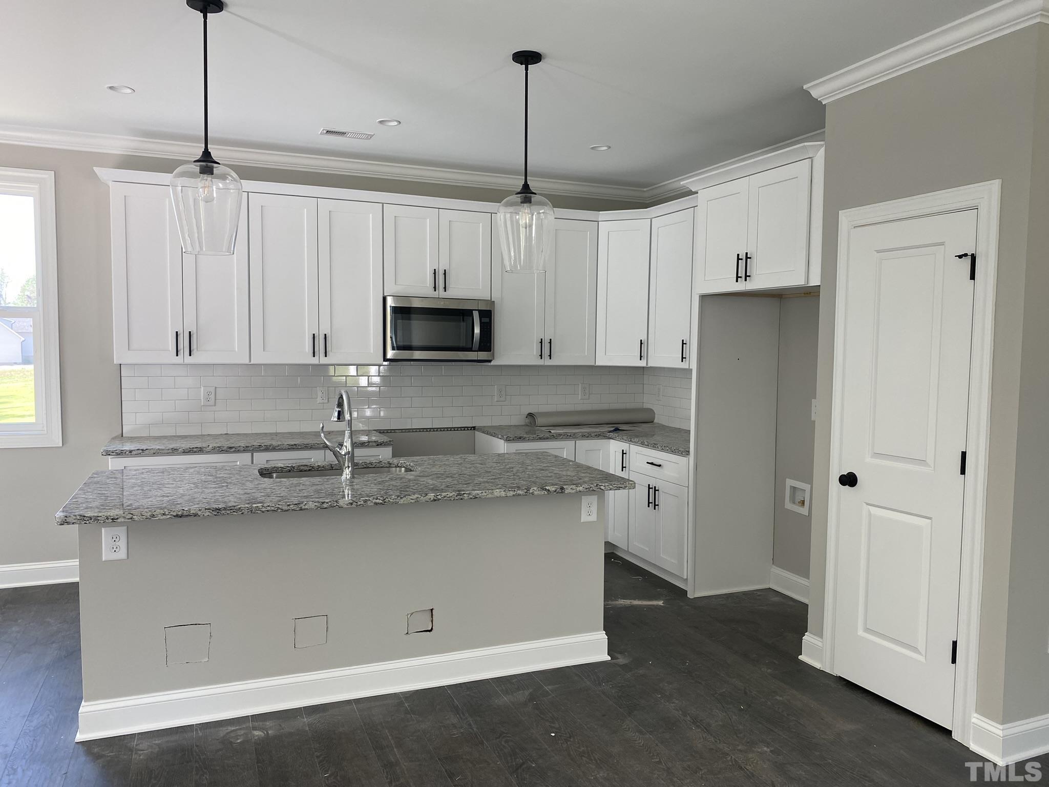 102 Buckstone Place Willow Spring, NC 27592 - Photo 5 of 25 a kitchen with appliances cabinets and a counter top space