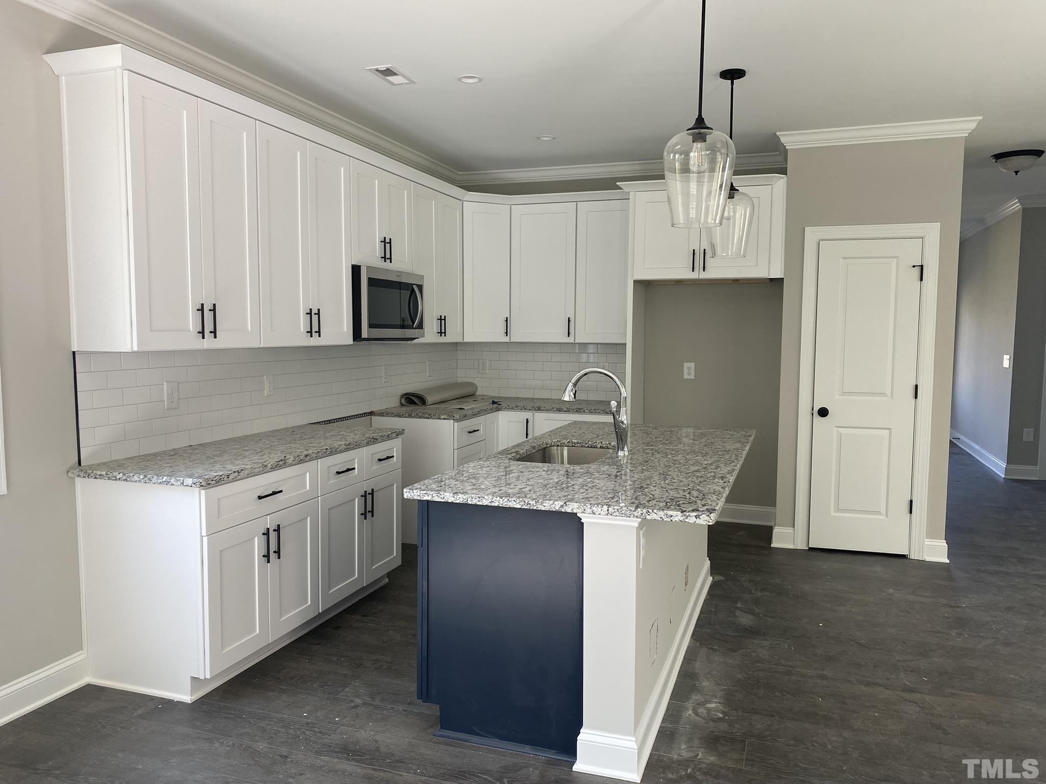 102 Buckstone Place Willow Spring, NC 27592 - Photo 6 of 25 a kitchen with stainless steel appliances granite countertop a sink and refrigerator