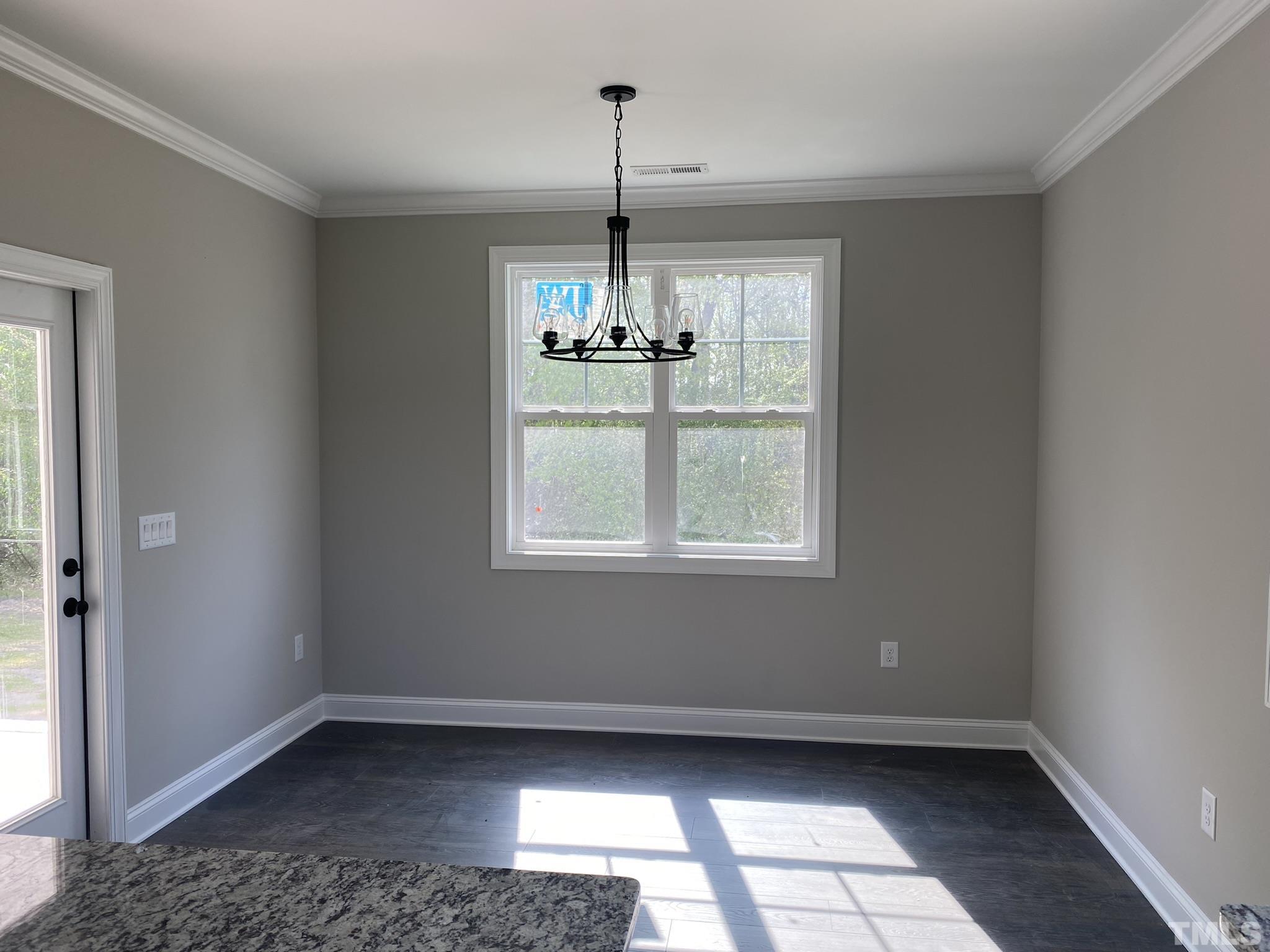 102 Buckstone Place Willow Spring, NC 27592 - Photo 7 of 25 a view of an empty room with a window