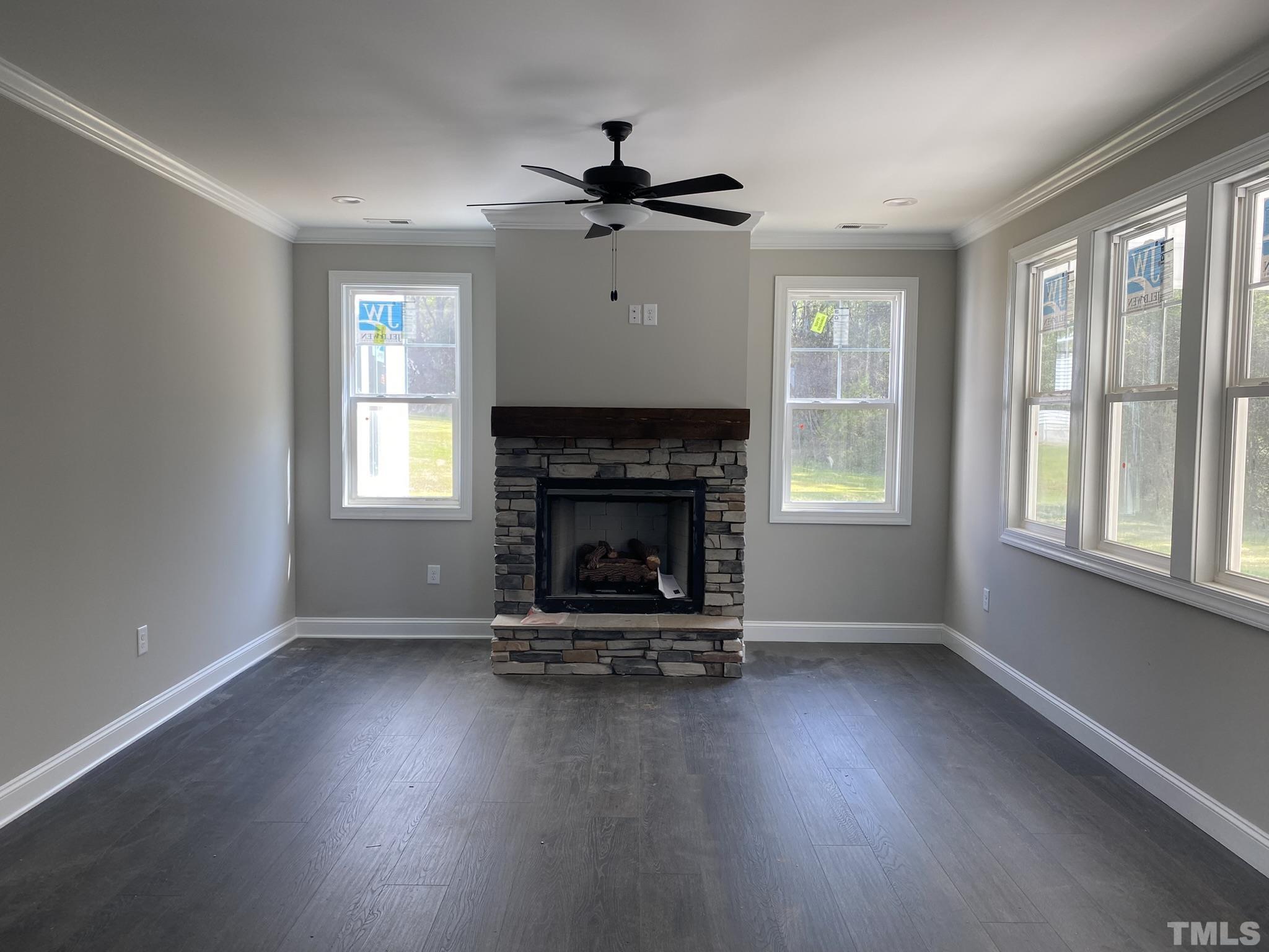 102 Buckstone Place Willow Spring, NC 27592 - Photo 8 of 25 a living room with hard wood floors and a fireplace