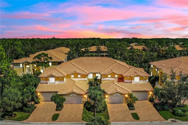 an aerial view of residential houses with outdoor space and street view