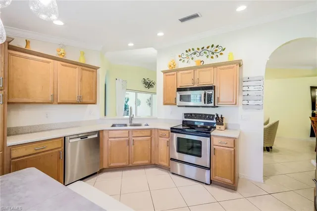 a kitchen with stainless steel appliances granite countertop a stove sink and cabinets