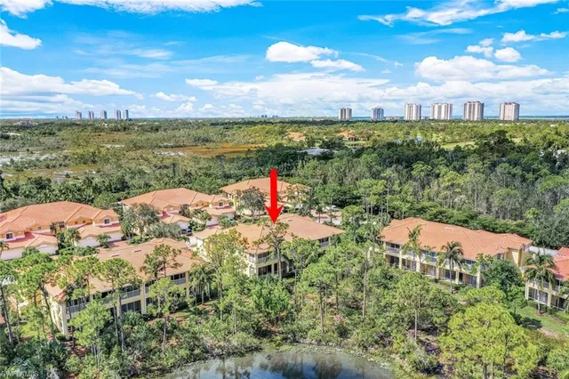 a view of a lake with houses in the back