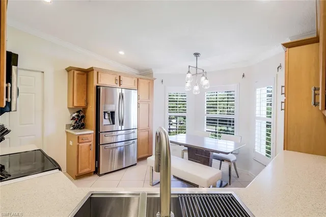a kitchen with stainless steel appliances a refrigerator and a stove top oven