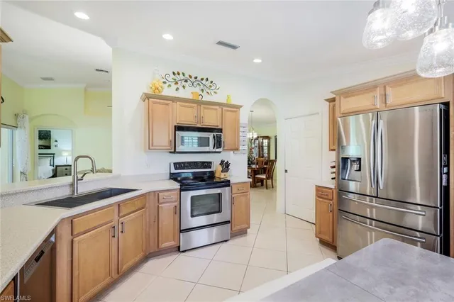 a kitchen with a sink stainless steel appliances and cabinets