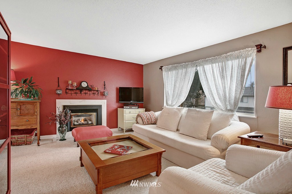 611 204th Street Southeast Bothell, WA 98012 - Photo 2 of 24 a living room with furniture a fireplace and a flat screen tv