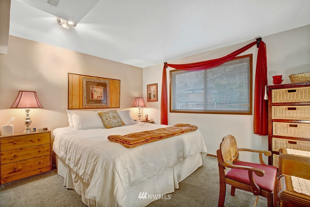 611 204th Street Southeast Bothell, WA 98012 - Photo 13 of 24 a bedroom with a bed a lamp and a large window