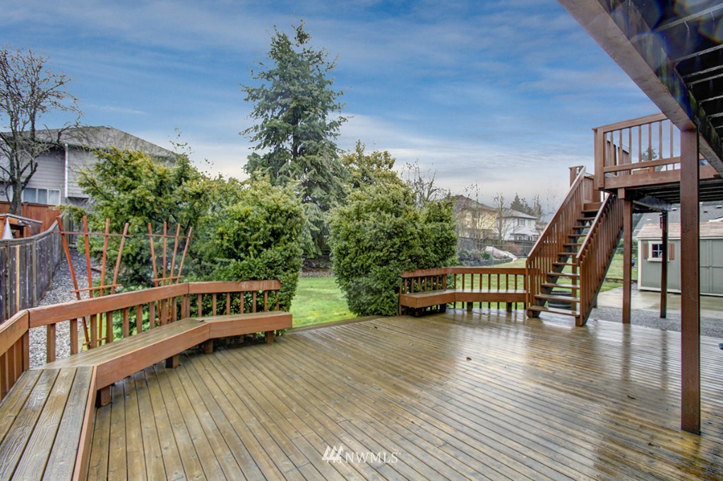 611 204th Street Southeast Bothell, WA 98012 - Photo 20 of 24 a balcony with wooden floor and outdoor seating