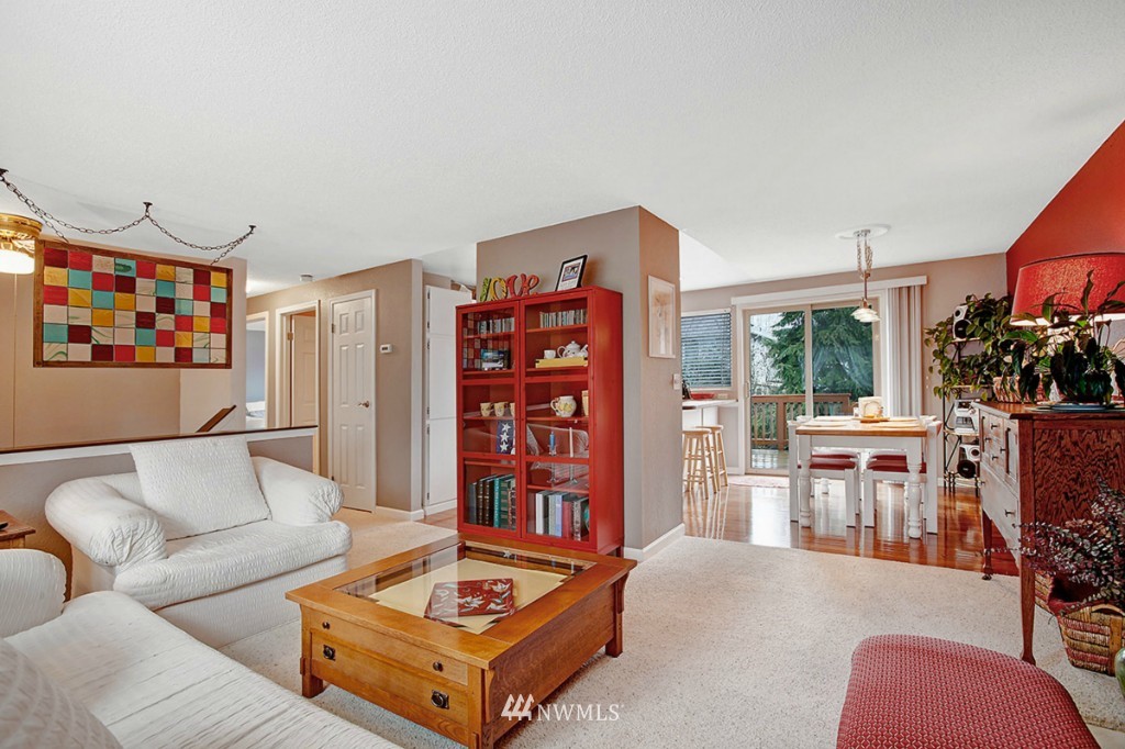 611 204th Street Southeast Bothell, WA 98012 - Photo 4 of 24 a living room with furniture a flat screen tv and a floor to ceiling window